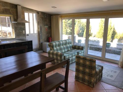 a living room with a couch and a table and chairs at Quinta do Atoleiro in Lamego