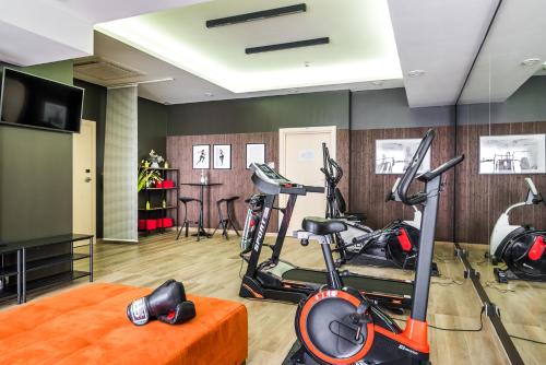 a gym with two exercise bikes in a room at Hotel Luxor in Lublin