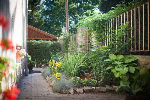 a garden with a fence and some plants and flowers at Villa Cecile in Sopron