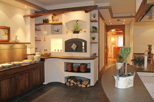 a kitchen with a counter with a fire place at Landhotel Traube in Seewald