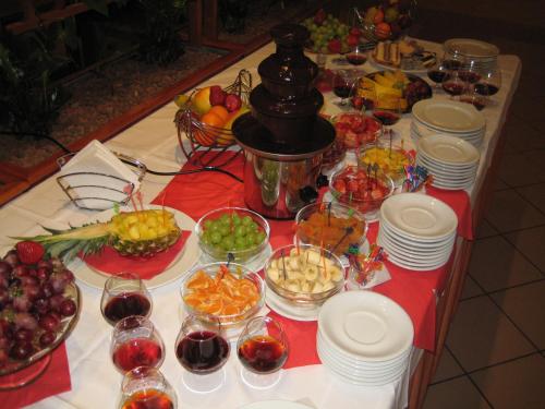 a table topped with plates and bowls of fruit at Gostisce Golob in Zgornja Polskava