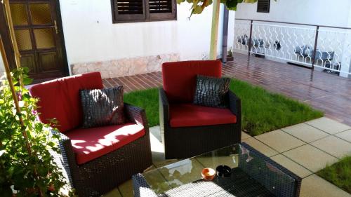 two chairs and a coffee table on a patio at Rooms Koblar in Portorož