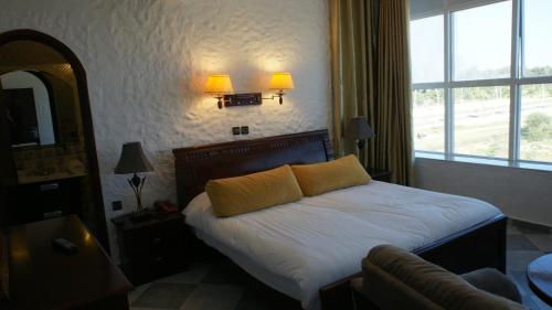 Postel nebo postele na pokoji v ubytování Hotel Hacienda