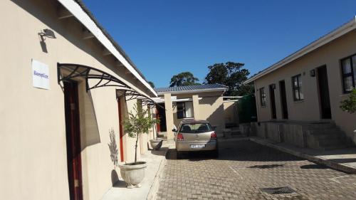 a car parked in the driveway of a house at Emampingeni lodge in Bizana