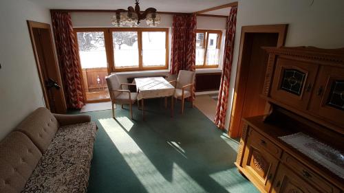 a living room with a table and chairs and a couch at Haus Christof in Holzgau