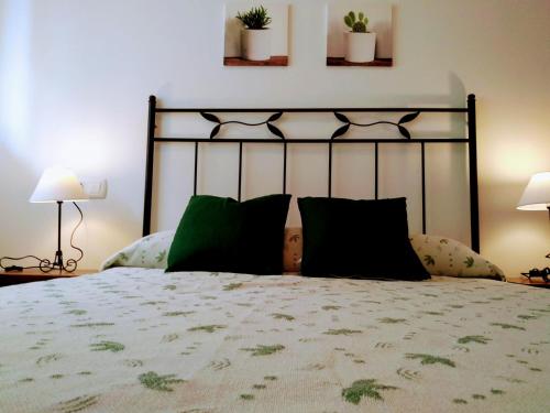a bedroom with a large bed with green pillows at desolyplaya Colomeras 2J in Oropesa del Mar