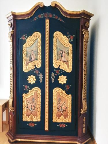 a grandfather clock with paintings on it at Fuchsenlohe in Schlier