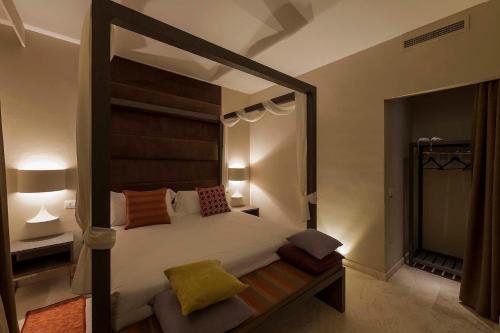A bed or beds in a room at Tenuta San Masseo - boutique farm resort & SPA