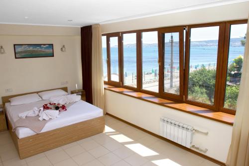 a bedroom with a bed with a view of the ocean at Mileta Hotel in Feodosia