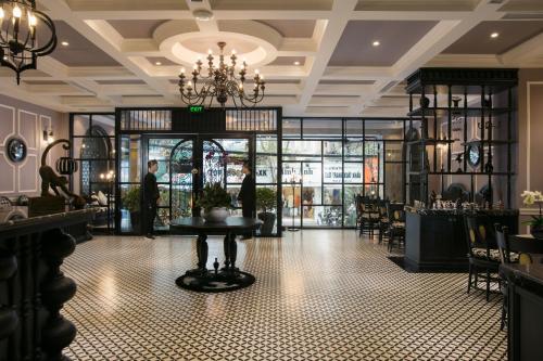 a restaurant with a table in the middle of a room at JM Marvel Hotel & Spa in Hanoi