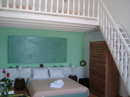a bedroom with a bed and a stair case at Manos Small World in Firostefani