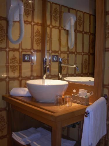 a bathroom with a white sink and a mirror at Le Cordonant in Cordon
