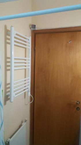 a room with a wooden door and a heater at Ladadika Studios in Thessaloniki