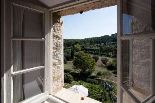 an open window with a view of the countryside at Le Manoir de L'Étang in Mougins
