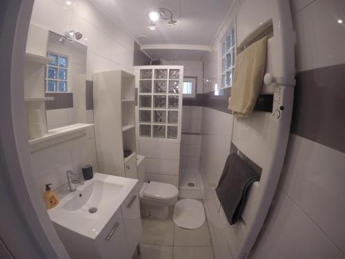 a white bathroom with a toilet and a sink at T2 Hyper centre clim,WIFI in Hyères