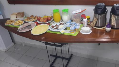 a table with food on it in a kitchen at Madame Lynch Hotel Asuncion in Asuncion