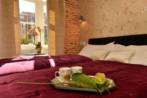 a tray of food sitting on top of a bed at Center Suite Santander in Santander