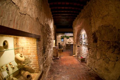 a hallway in an old building with a brick wall at Hotel Museo Spa Casa Santo Domingo in Antigua Guatemala