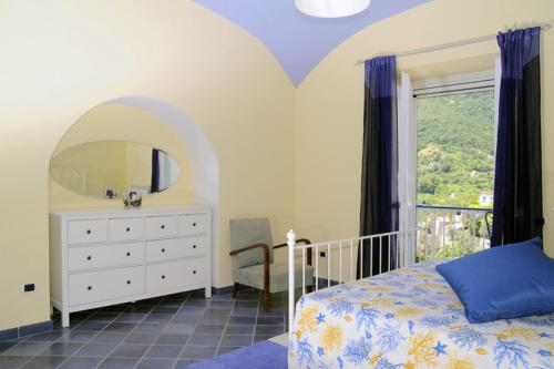 a bedroom with a bed and a dresser and a mirror at Le terrazze di Cristina in Vietri