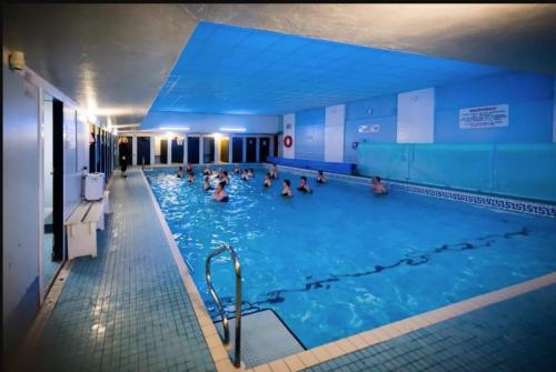 a group of people swimming in a swimming pool at The Warwick Southport in Southport