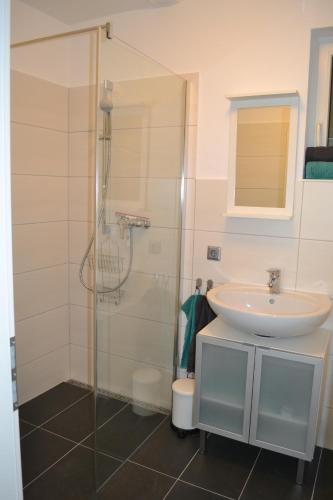 a bathroom with a sink and a shower at Fewo Grenzach in Grenzach-Wyhlen