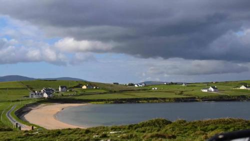 a view of a beach with houses and a body of water at Cannon Cottage in St John's Point