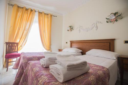 Postel nebo postele na pokoji v ubytování Hotel Grifo