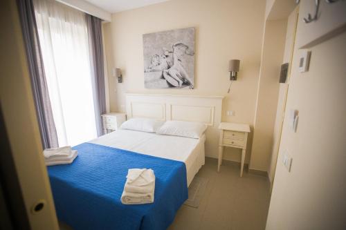 Postel nebo postele na pokoji v ubytování Hotel Grifo