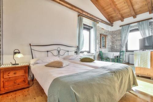 a bedroom with a large bed and a wooden floor at Casa Romantica La Parenzana in Buje