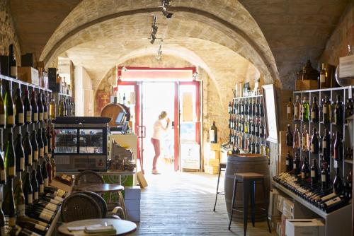 a woman standing at the door of a wine store at Bordeaux Village Blaye in Blaye