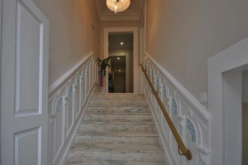 a staircase in a home with a chandelier at Porto Charming Hotel in Porto