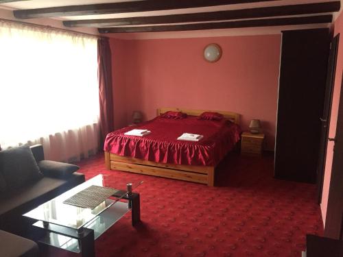 a bedroom with a bed in a red room at Penzion- Leslav in České Budějovice