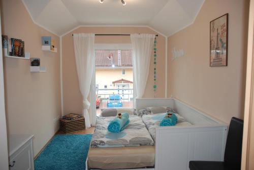 um pequeno quarto com uma cama e uma banheira em Ferienwohnung Blumäcker Oberbayern em Oberhausen