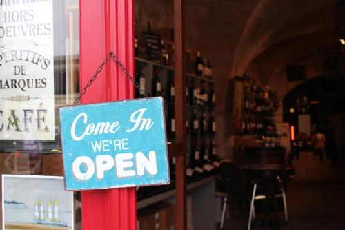 a sign that says come in were open in a store at Bordeaux Village Blaye in Blaye