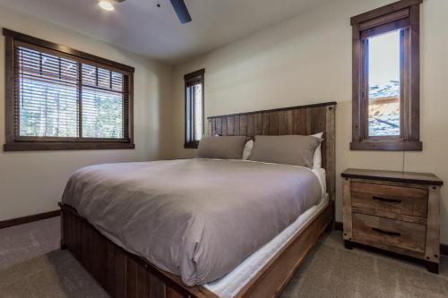a bedroom with a large bed and two windows at Gray Bear 454 in Mammoth Lakes