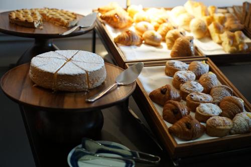 a display of different types of donuts and other pastries at Hotel Lungarno - Lungarno Collection in Florence