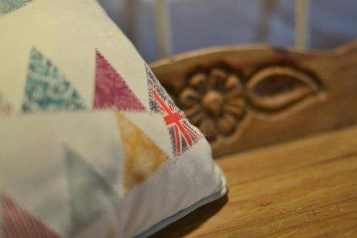 a book sitting on a table next to a bed at The Burrow Guest House in Tarxien