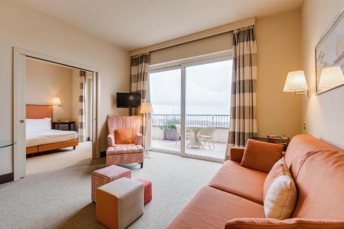 a living room with a couch and a bed at Villa Maria Hotel & SPA in Francavilla al Mare