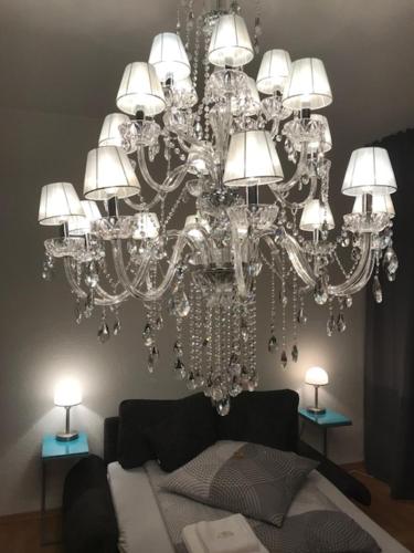 a large chandelier in a living room with a couch at Apartment Erfurt Mitte in Erfurt