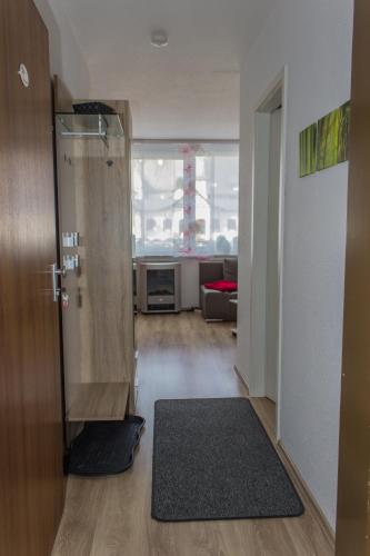 a room with a shower and a door with a rug at Snow in Winterberg
