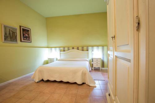 a bedroom with a bed with a white blanket at Camere Centro Storico in Canelli