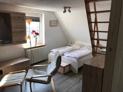 a small bedroom with a bed and a chair at Heaven in Winterberg