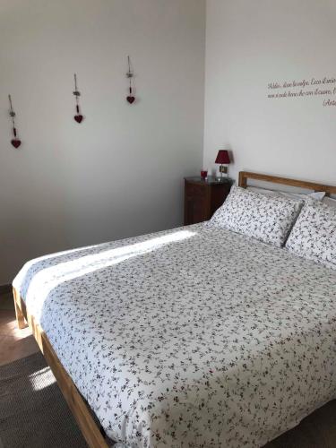 a bedroom with a bed with a floral bedspread at casa vacanze il gelsomino in Nocera Umbra