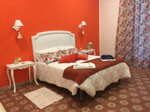 a bedroom with a bed with red walls at B&B Resta Cu Mme in Naples