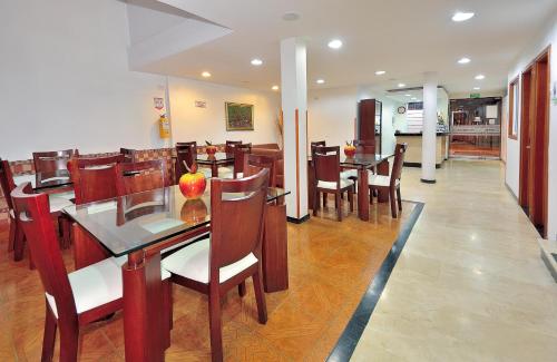 a dining room with wooden tables and chairs at Hotel Palonegro in Bucaramanga