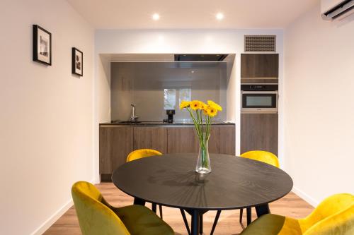 a vase of flowers on a table in a kitchen at Logement Den Beer in Meerhout