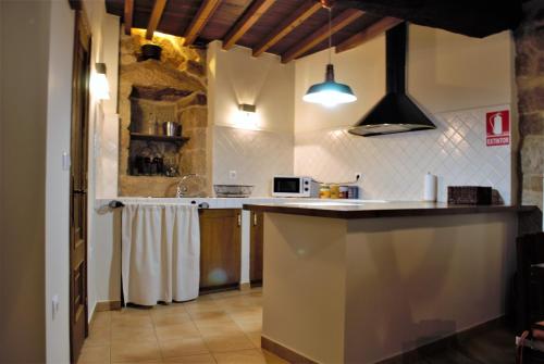a kitchen with a sink and a counter top at A Lareira De Allariz in Allariz