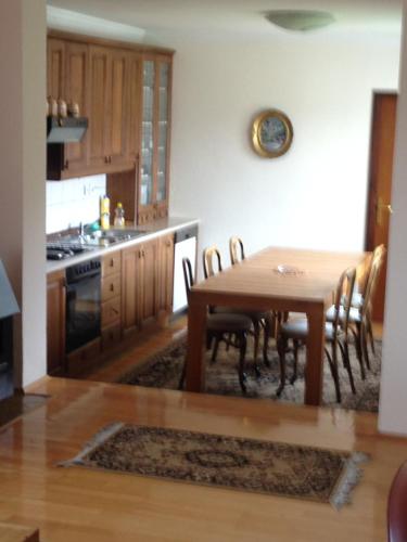 a kitchen and dining room with a table and chairs at Apartments Kenedy in Kiseljak