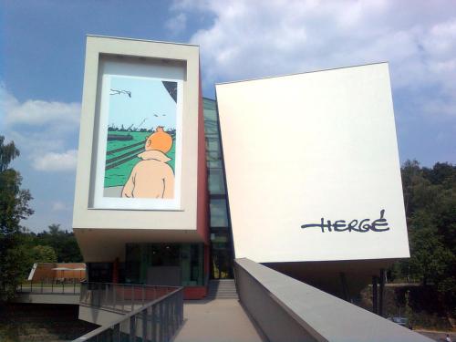 a building with a large window with a cartoon at Sakura Lodging in Bossut-Gottechain