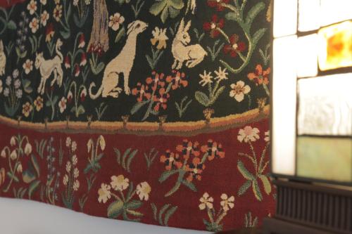 a blanket with cats and flowers on a wall at Art de Sejour - B&B in Brussels
